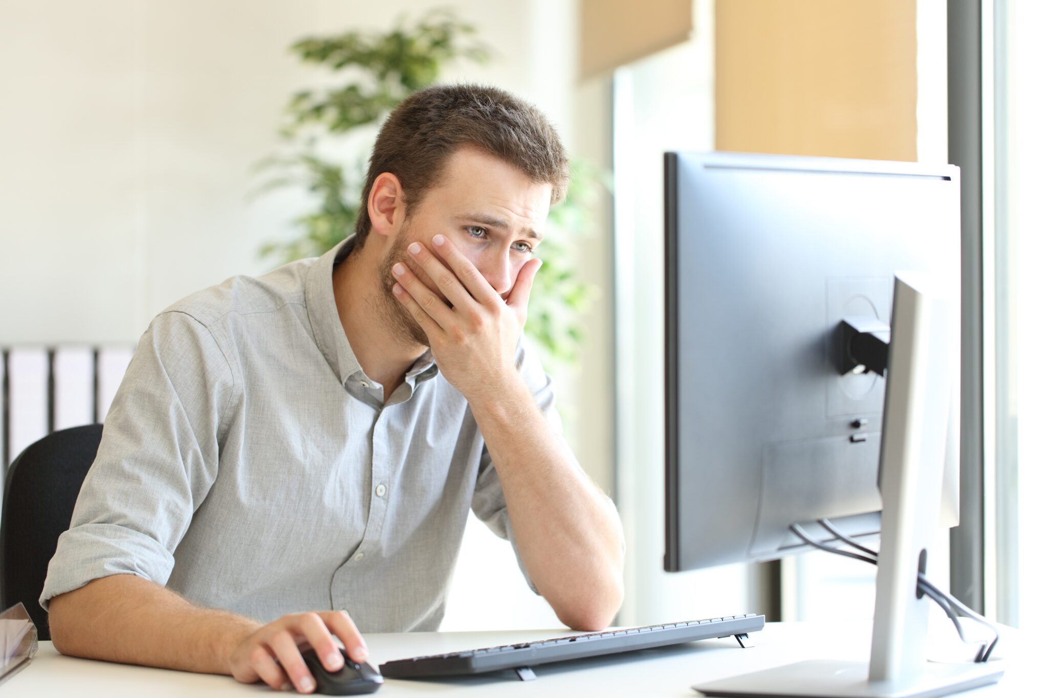 Worried businessman working online