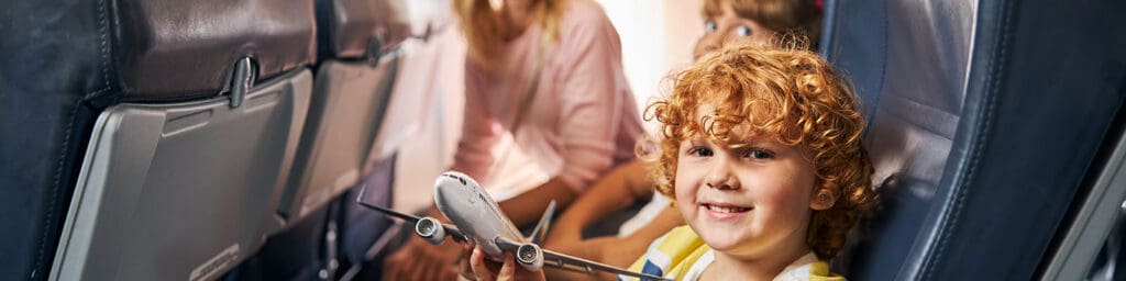 A cheerful child playing with a toy airplane