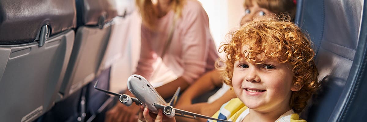 A cheerful child playing with a toy airplane
